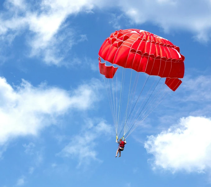 a person is parasailing in the blue sky, pexels contest winner, red velvet, head down, avatar image, soft shade