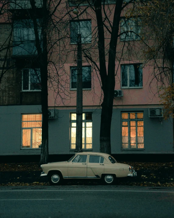 a car is parked in front of a building, unsplash contest winner, socialist realism, autumn lights colors, ignant, low quality photo, 80s photo