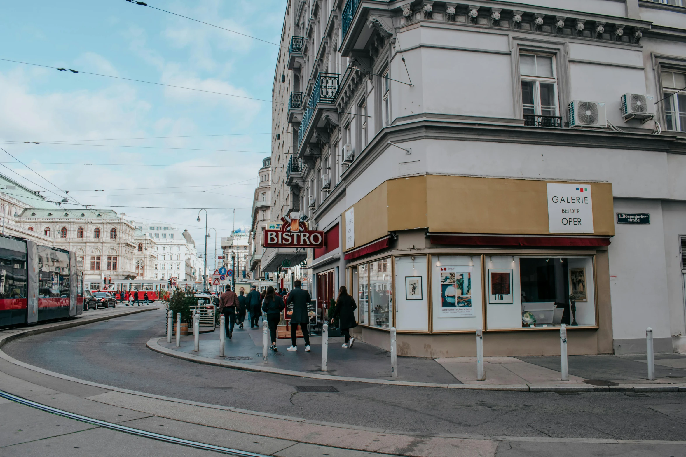 a group of people walking down a street next to a bus, by Emma Andijewska, pexels contest winner, art nouveau, diner caffee, city panorama, austrian architecture, 2 0 0 0's photo