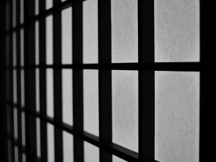 a black and white photo of a window, inspired by Sesshū Tōyō, unsplash, minimalism, behind bars, zoomed in, 3d cell shaded, wikimedia commons