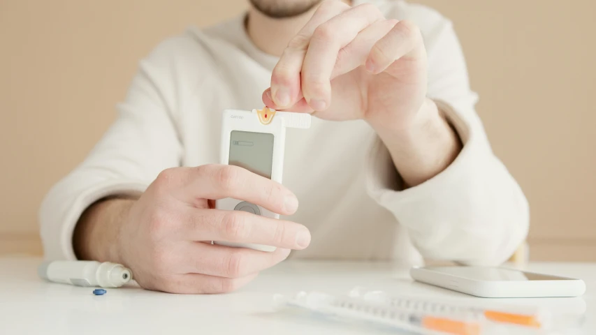 a close up of a person holding a cell phone, holding a syringe, holding a wood piece, product shot, performing