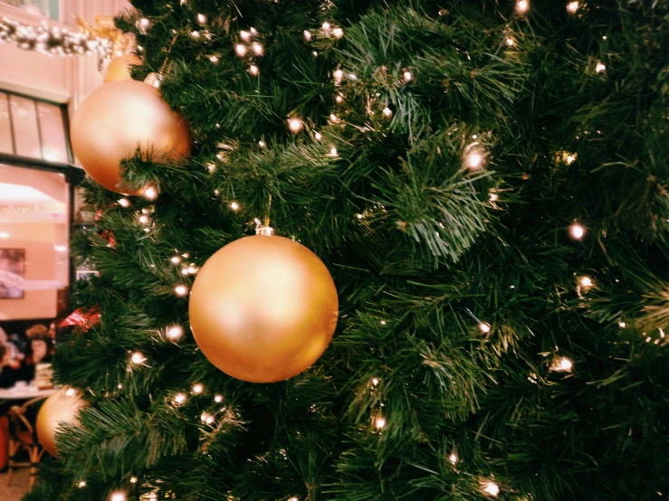 a close up of a christmas tree with gold ornaments, by Carey Morris, pexels, hanging out with orbs, black fir, avatar image, panels