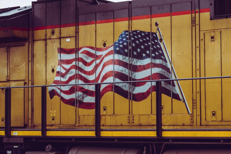 an american flag painted on the side of a train, a portrait, unsplash, yellow, 🚿🗝📝, retro style ”, graphic print