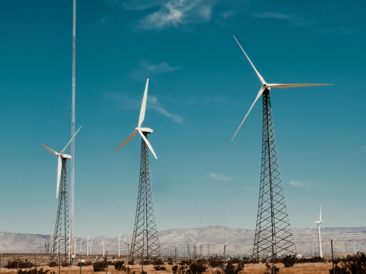 a group of wind turbines sitting on top of a dry grass field, pexels contest winner, southern california, tall metal towers, unsplash 4k, instagram post