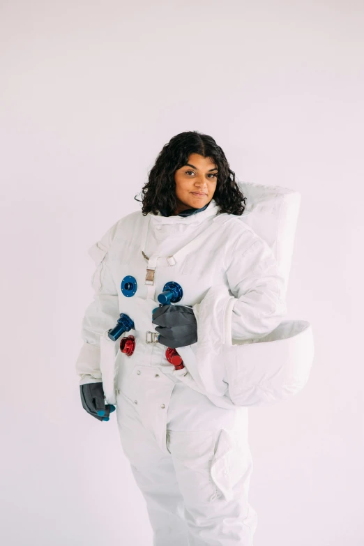 a woman in an astronaut suit holding a pillow, by Winona Nelson, trending on unsplash, imaan hammam, on white, life size, sarah andersen