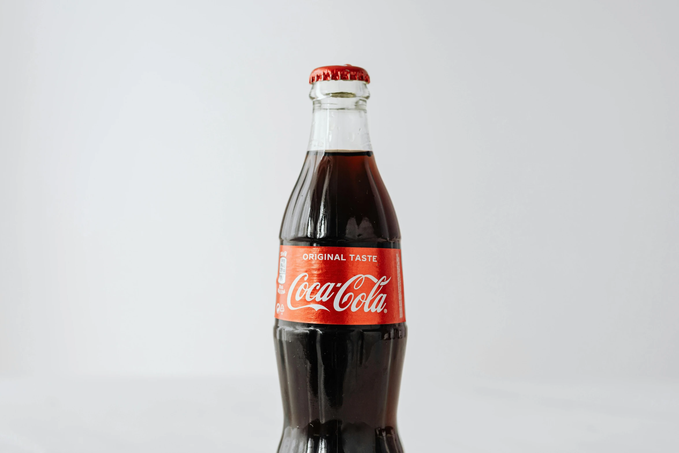 a bottle of coca cola sitting on top of a table, in a medium full shot, fan favorite, traditional medium, product shot