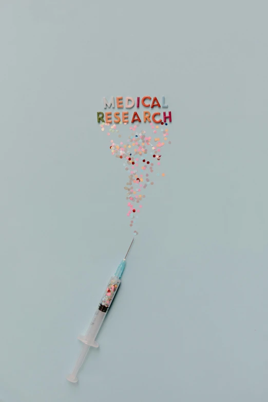 a syll flying through the air with the words medical research written on it, trending on pexels, holding a syringe, glitter gif, flat lay, profile picture