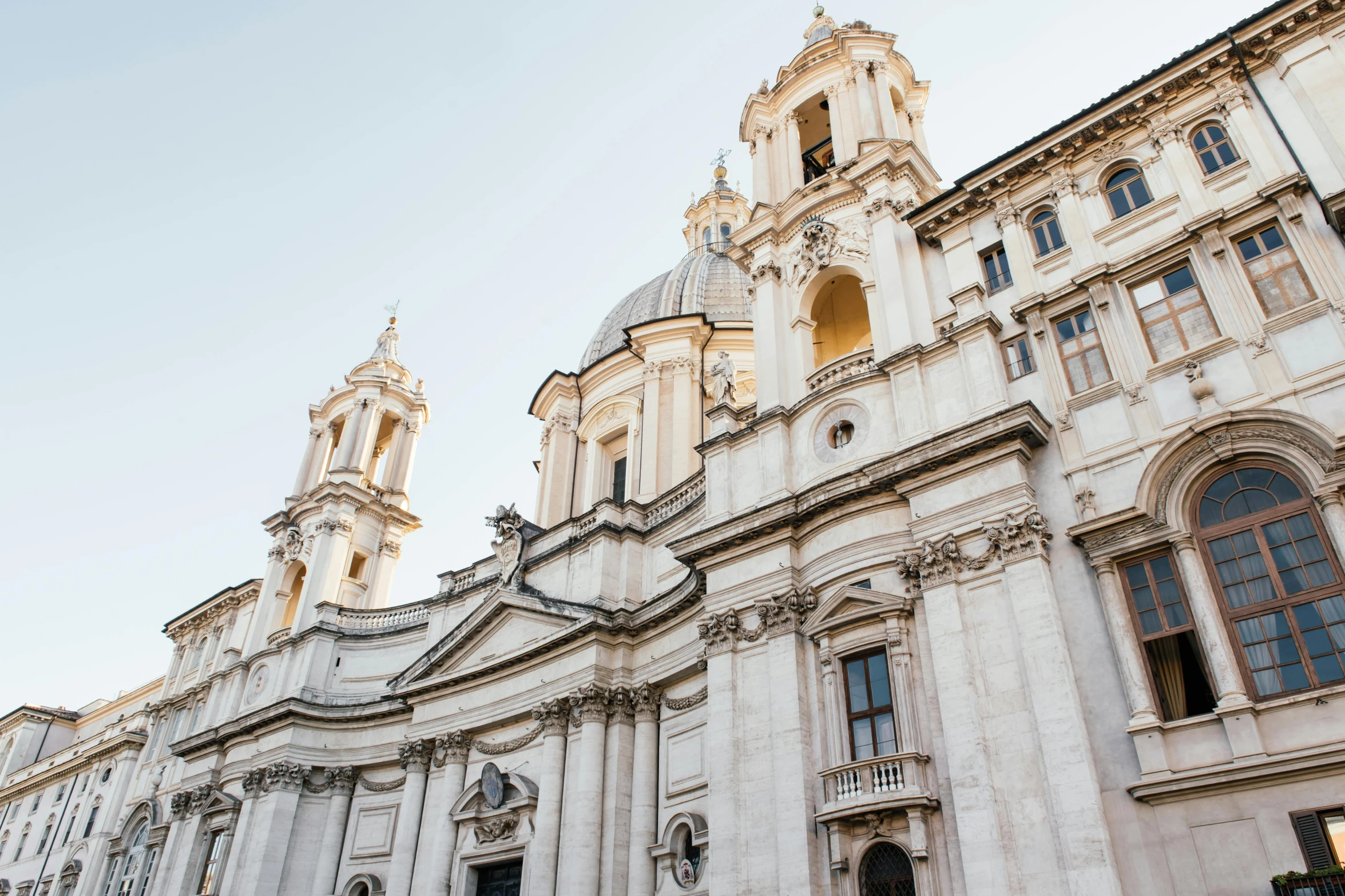 a couple of people that are standing in front of a building, by Gian Lorenzo Bernini, pexels contest winner, the pope wakes up is his bed, domes, front and side elevation, white building