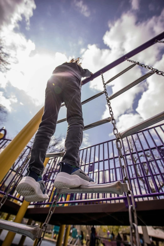 a person standing on a ladder in a playground, by Niko Henrichon, wideangle action, highly upvoted, walking at the park, high-resolution