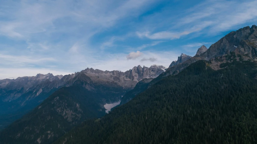 a group of people standing on top of a mountain, pexels contest winner, les nabis, lush forest in valley below, italy, ultrawide angle cinematic view, distant mountain range