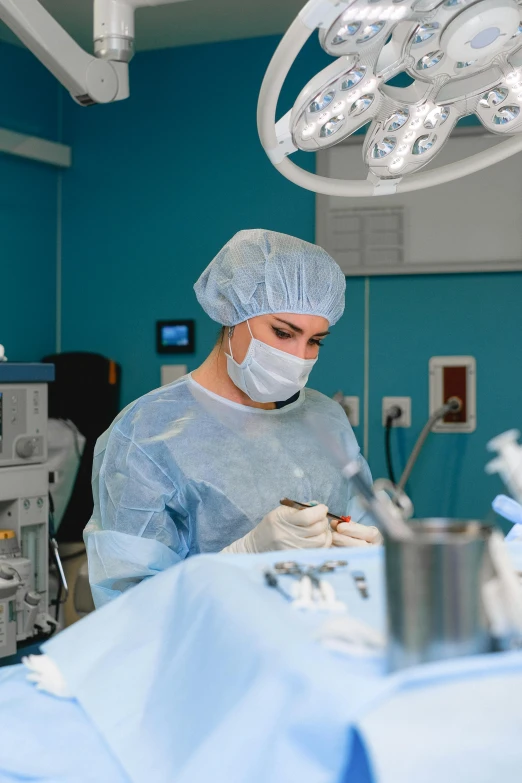 two surgeons working on a patient in an operating room, a picture, by Adam Marczyński, shutterstock, multiple stories, female model, thumbnail, inspect in inventory image