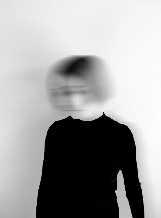 a black and white photo of a person with a hat on, a black and white photo, by Jan Rustem, conceptual art, blurred face, saatchi art, faceless, portrait of an android