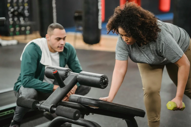 a man and a woman working out in a gym, by Emma Andijewska, pexels contest winner, curvy build, injured, bench, looking at the ground