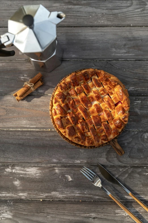 a pie sitting on top of a wooden table, on wooden table