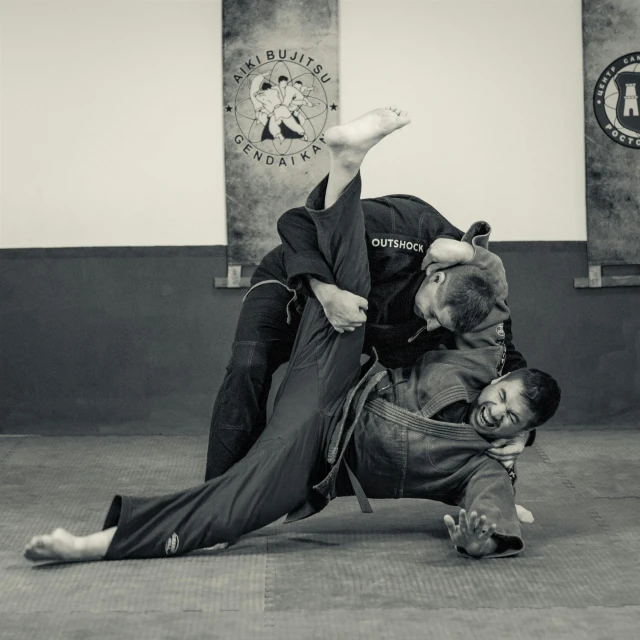 a couple of men standing on top of each other, a black and white photo, martial arts, kajo baldisimo and craig mullins, half - turn, alfric overguard