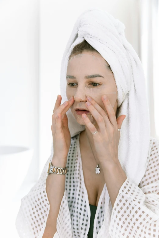 a woman with a towel on her head talking on a cell phone, by Julia Pishtar, flawless epidermis, square facial structure, in the morning, silicone skin