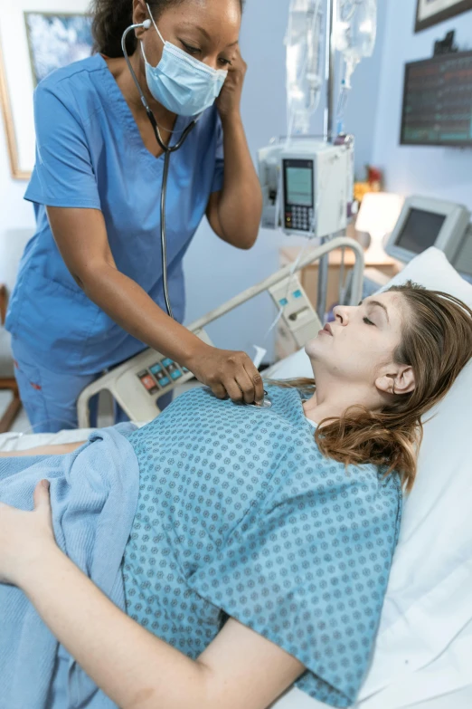 a woman laying in a hospital bed next to a nurse, profile image, talking, insanely inflated hips, intubation equipment