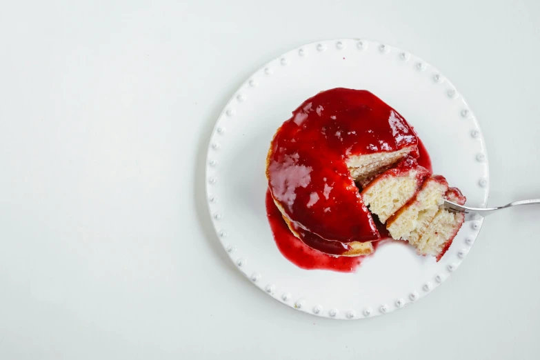 a white plate topped with a piece of cake, inspired by Richmond Barthé, unsplash, spilling ketchup, pancakes, red color bleed, glaze