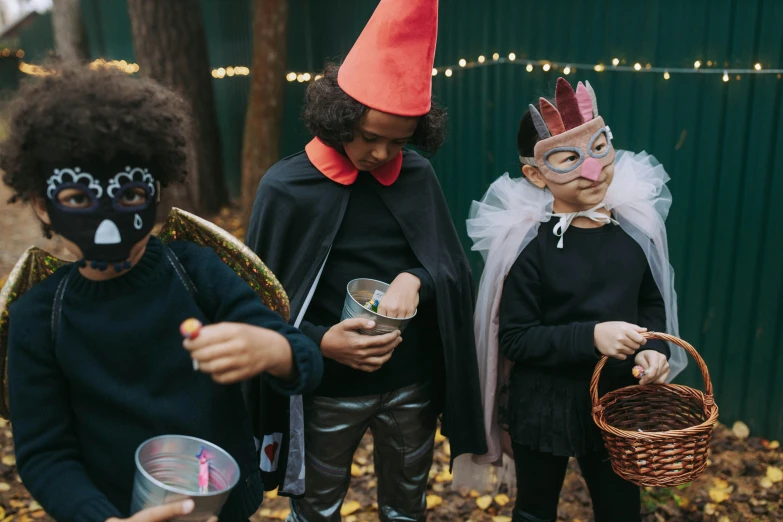 a group of children dressed up in halloween costumes, by Emma Andijewska, pexels contest winner, forest picnic, letterboxing, chalk, the little circus of horrors