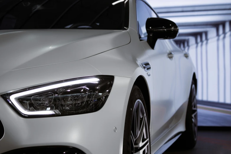 a white car parked in a parking garage, a digital rendering, inspired by An Gyeon, pexels contest winner, photorealism, glowing oled visor, close up. macro. hyper realistic, mercedez benz, side lighting xf iq4