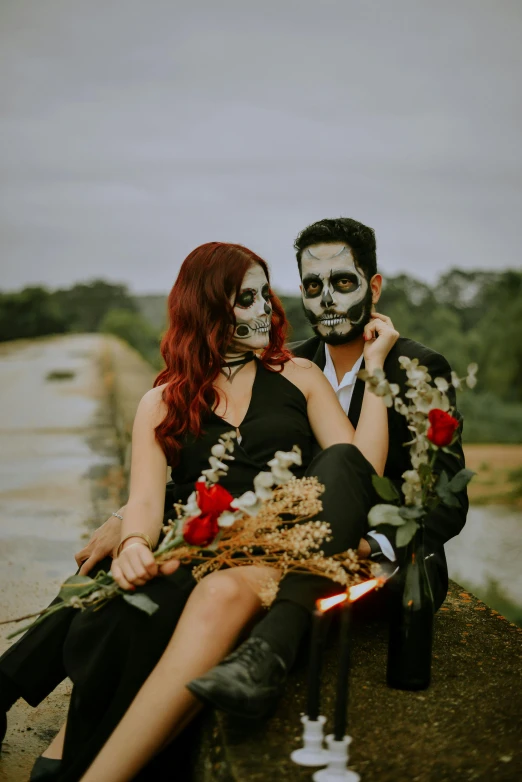 a man and a woman sitting next to each other, pexels contest winner, international gothic, skull bones flowers, carrying flowers, black and terracotta, zombie ghouls