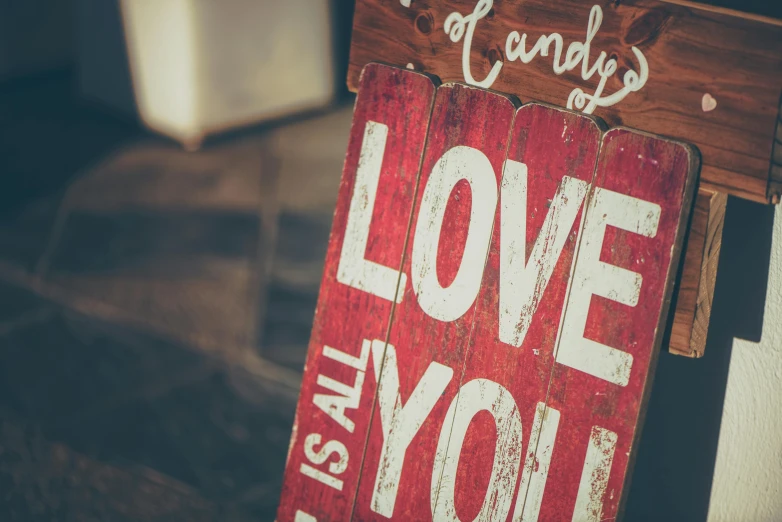 a wooden sign with the words i love you written on it, a picture, unsplash, red and brown color scheme, andy worhol, love is begin of all, devon cady-lee