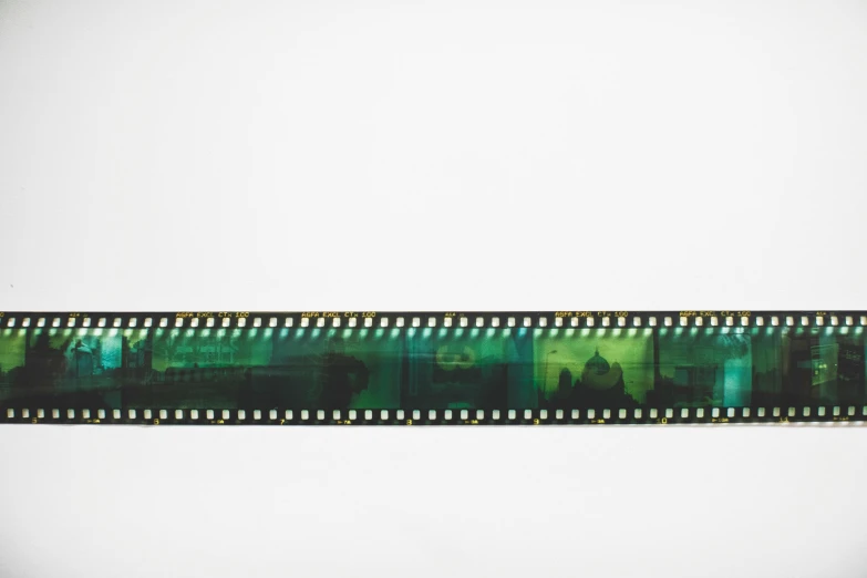a close up of a film strip on a white background, inspired by Raoul Ubac, unsplash, video art, gradient black green gold, skyline, 5 0 mm 1 9 4 6 historical photo, shot on hasselblad