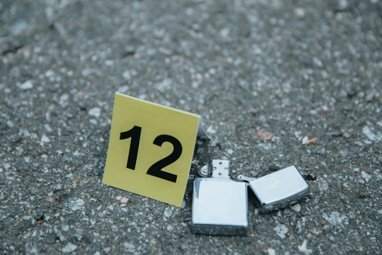 a couple of lighters that are on the ground, by Elsa Bleda, serial art, crime scene photo, gettyimages, 1 2 - bit, cubic