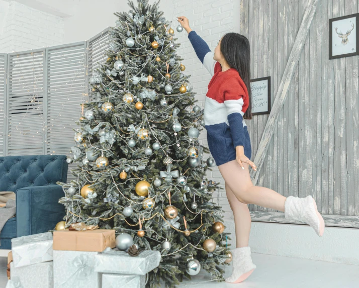 a woman decorating a christmas tree in a living room, pexels contest winner, arabesque, standing on two legs, tzuyu from twice, grey, ultra-realistic