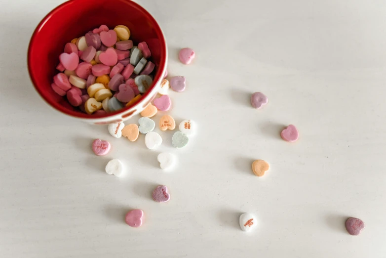 a red bowl filled with lots of candy, a picture, pexels, visual art, hearts symbol, shot on canon eos r5, candy pastel, porcelain