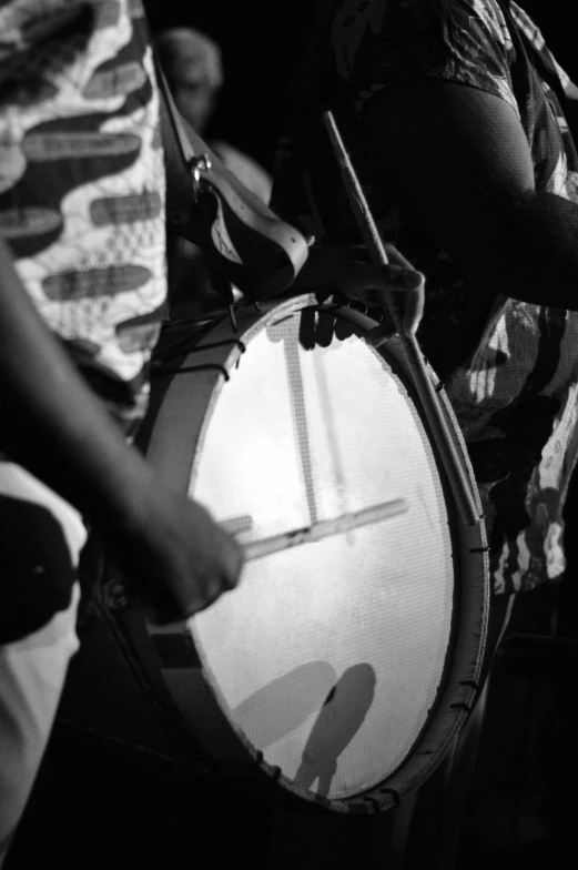 a group of people that are playing drums, by Nathalie Rattner, hurufiyya, tri - x pan stock, holding a shield, closeup!!!!!, uploaded