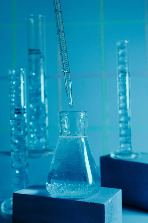 a group of test tubes sitting on top of a table, sapphire, pouring, thumbnail, atmospheric