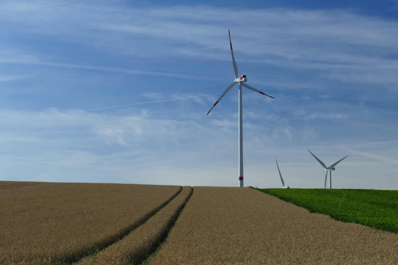 a couple of wind turbines sitting on top of a field, by Jan Tengnagel, pexels contest winner, horizon forbideen west, view from the ground, northern france, no cropping