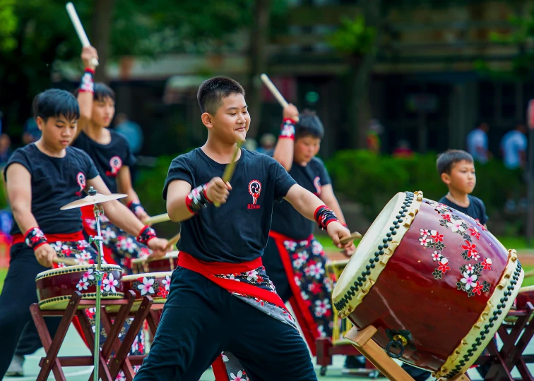 a group of people playing a game of drums, inspired by Miao Fu, pexels contest winner, shin hanga, avatar image, japanese school uniform, in hong kong, kung-fu