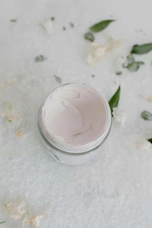 a jar of cream sitting on top of a snow covered ground, lavender blush, detailed product image, close up half body shot, mask