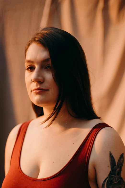 a woman in a red tank top posing for a picture, an album cover, pexels contest winner, arya stark, portrait soft light, lgbtq, portrait of sanna marin