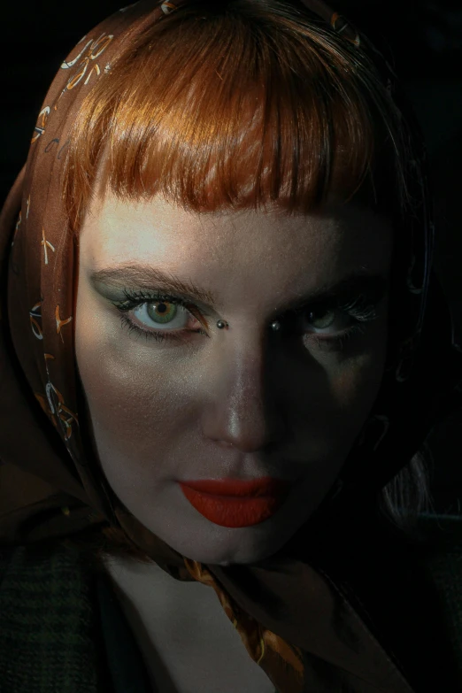 a woman with red hair wearing a scarf, an album cover, inspired by Hans Baldung, featured on zbrush central, movie still from bladerunner, unreal engine : : rave makeup, high angle closeup portrait, steven klein