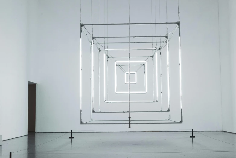 a white room with a light hanging from the ceiling, unsplash, kinetic art, square, connected with glowing tubes 8 k, ( mechanical ), elliot alderson