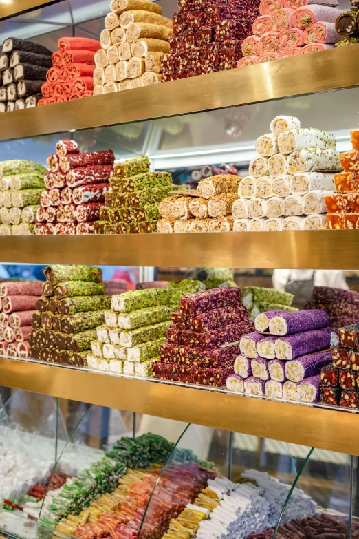 a display case filled with lots of different types of candy, emir, in background, rows of lush crops, an elegant