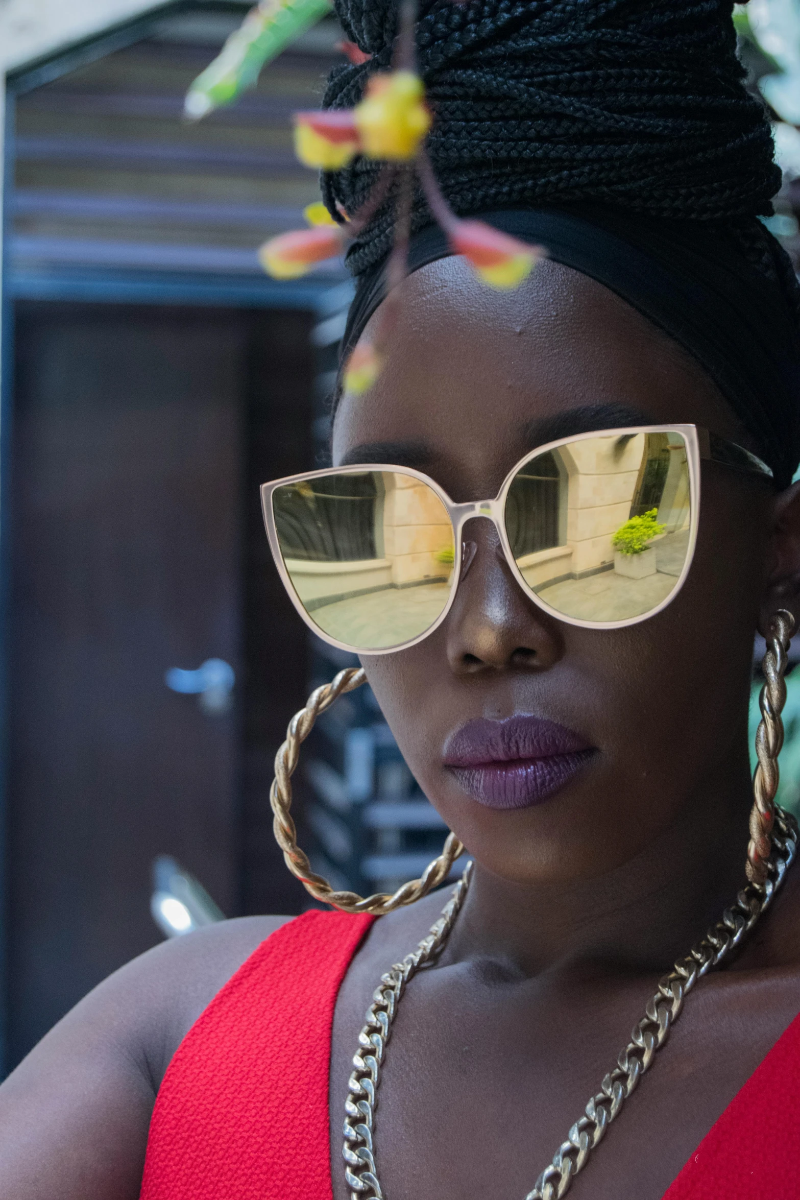 a woman in a red dress and gold sunglasses, trending on unsplash, afrofuturism, mirror shades, shot with sony alpha, square rimmed glasses, shaven