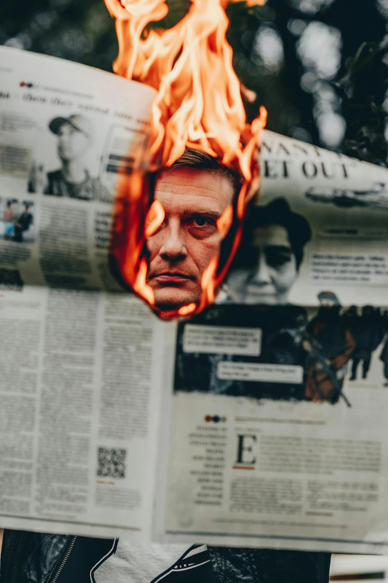 a person holding a newspaper in front of a fire, by Adam Marczyński, trending on reddit, renaissance, portrait of mélenchon, distorted photo, scowling, human torch