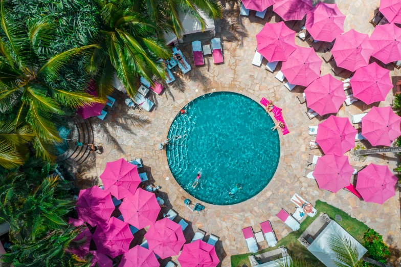 an aerial view of a pool with pink umbrellas, a portrait, pexels contest winner, maui, fisheye effect, 🎀 🧟 🍓 🧚, sol retreat