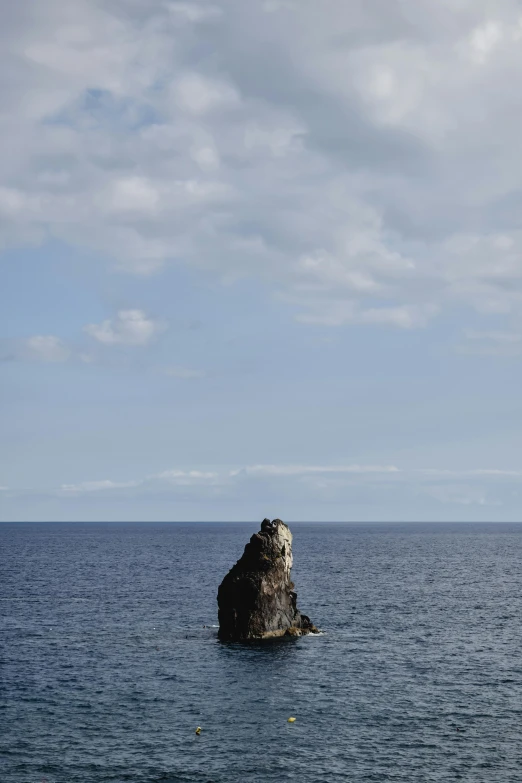 a large rock in the middle of a body of water, by Yasushi Sugiyama, minimalism, azores, cinq terre, on top of it, slide show