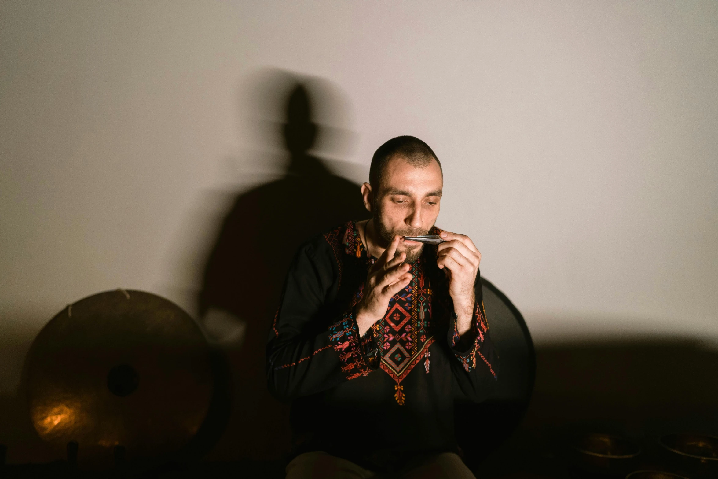 a man sitting on a couch playing a musical instrument, hurufiyya, profile image
