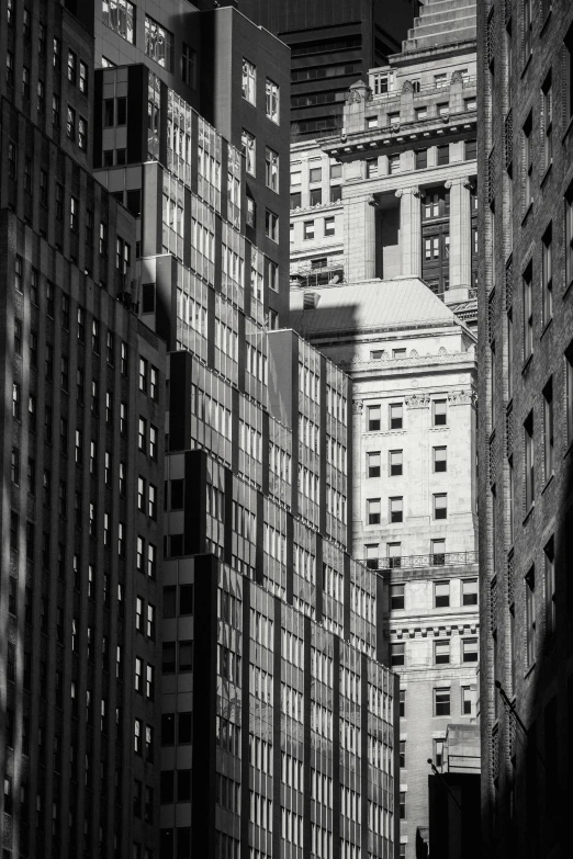 a black and white photo of a city street, inspired by André Kertész, precisionism, golden hour in manhattan, windows and walls :5, wall street, city rooftop