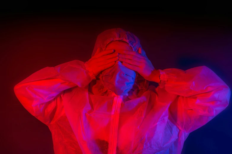 a woman covering her face with her hands, by Adam Marczyński, staff wearing hazmat suits, red and blue lighting, red and blue garments, healthcare