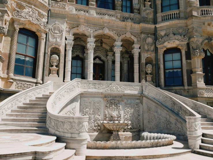 a large building with a fountain in front of it, a marble sculpture, inspired by Hedi Xandt, pexels contest winner, baroque, outdoor staircase, istanbul, victorian arcs of sand, decorated with soviet motifs