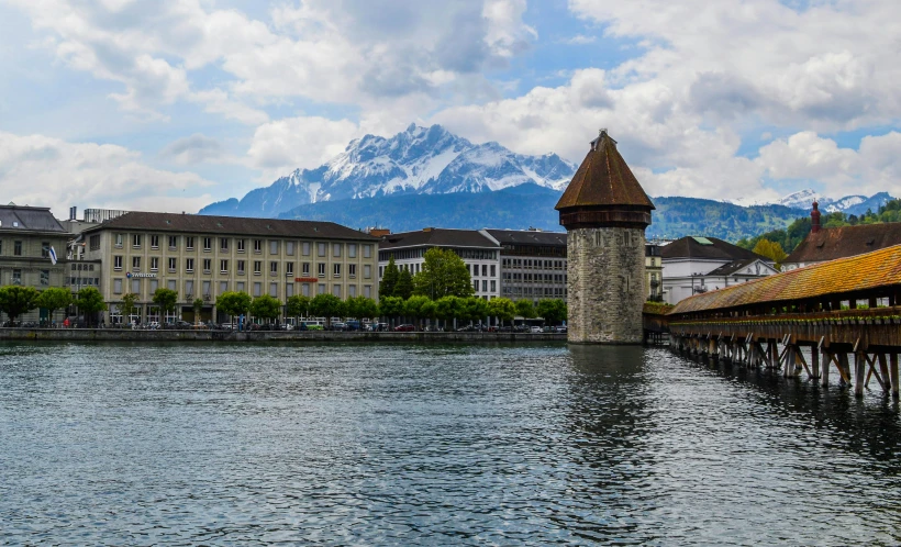 a bridge over a body of water with a mountain in the background, inspired by Karl Stauffer-Bern, pexels contest winner, renaissance, brutalist buildings tower over, where a large, meadows, a quaint