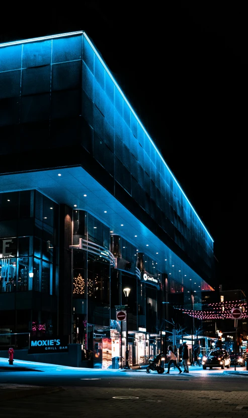 a building lit up with blue lights at night, by Sebastian Spreng, unsplash contest winner, altermodern, nightcafe, mall background, high quality photo, square