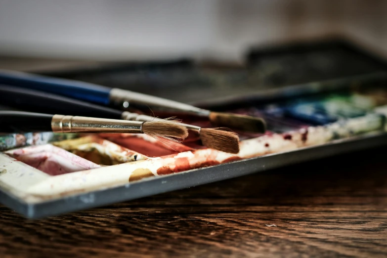 a tray of paint brushes sitting on top of a wooden table, a photorealistic painting, pexels contest winner, academic art, leaning towards watercolor, 🎨🖌, master life drawing, digital painting | intricate